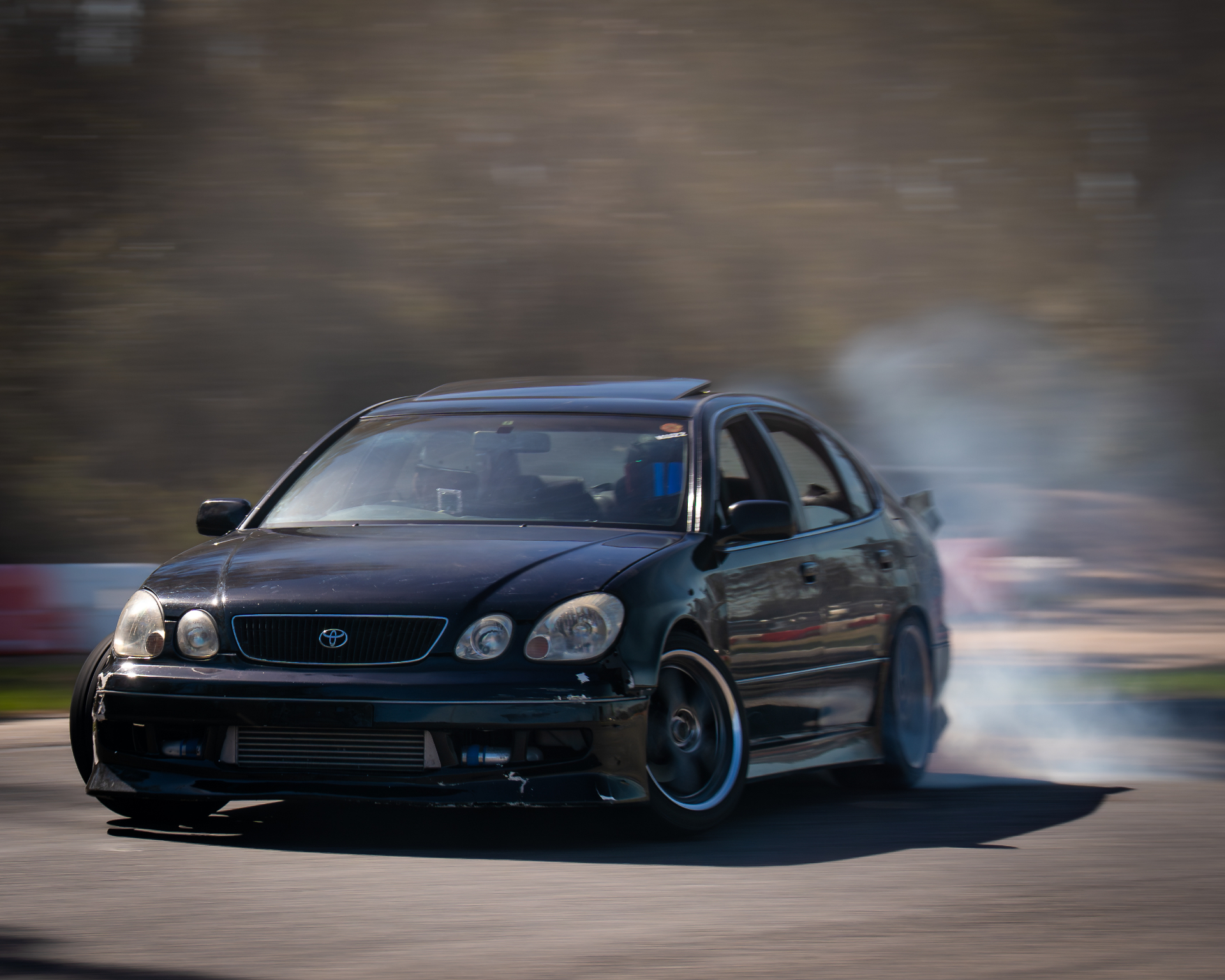 Black Toyota drifting, panning motion blur