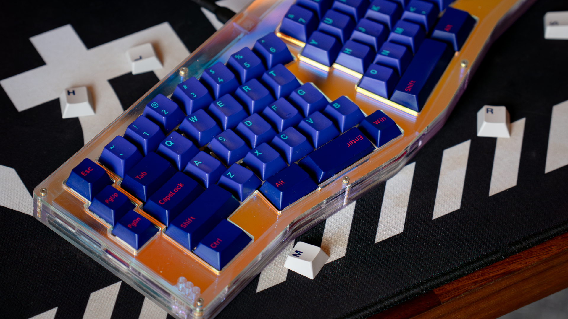 Alice ergonomic keyboard with navy GMK Laser keycaps on orange plate
